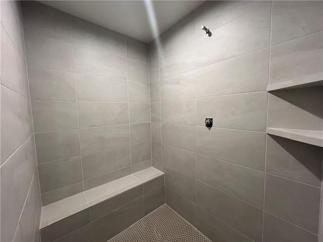 bathroom with a tile shower