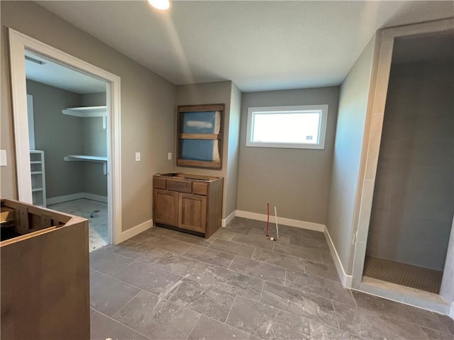 bathroom with vanity and a shower