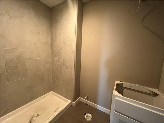 bathroom with a tile shower