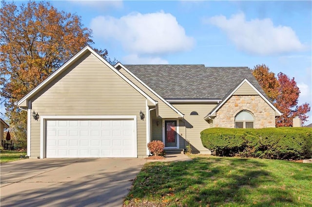 view of front of property with a garage and a front lawn