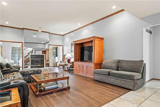 living room with crown molding and a towering ceiling