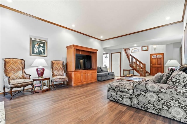 living room with hardwood / wood-style flooring and ornamental molding