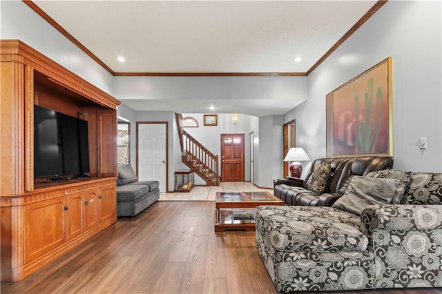 living room with hardwood / wood-style flooring and crown molding