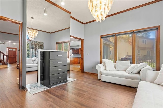 living room with hardwood / wood-style floors, a notable chandelier, and ornamental molding