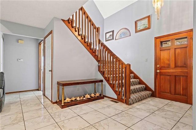 foyer entrance with a notable chandelier