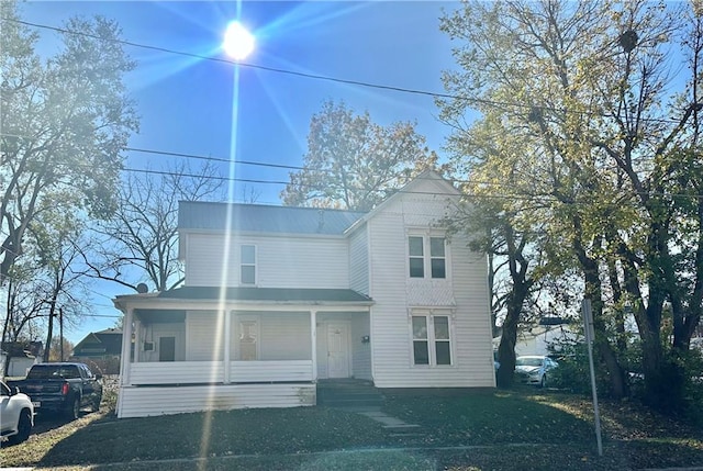 view of front of house featuring a front yard and a porch