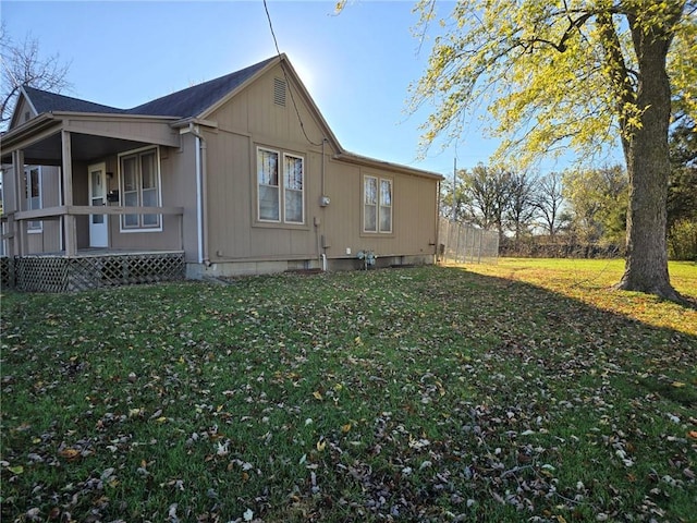 view of home's exterior with a porch and a yard