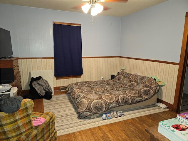 bedroom with hardwood / wood-style floors and ceiling fan