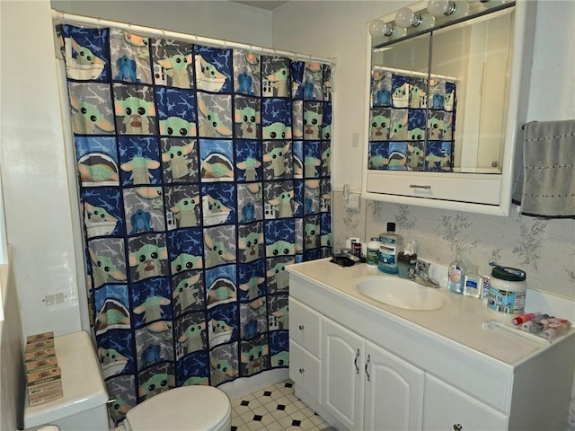 bathroom featuring vanity, toilet, and walk in shower