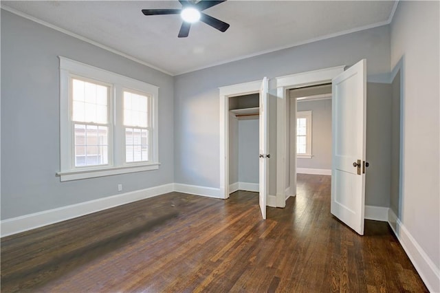 unfurnished bedroom featuring multiple windows, dark hardwood / wood-style floors, ceiling fan, and crown molding