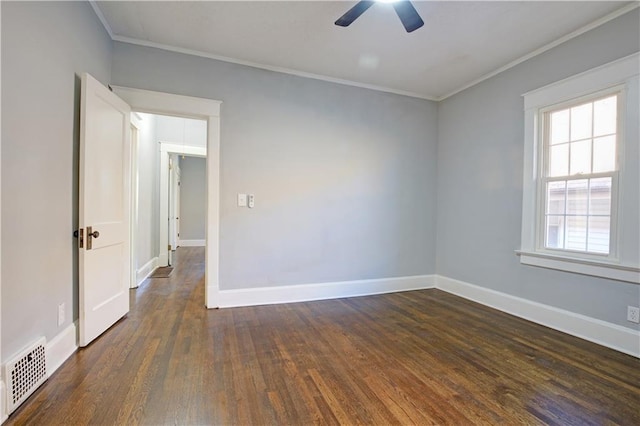 empty room with ceiling fan, ornamental molding, and dark wood-type flooring