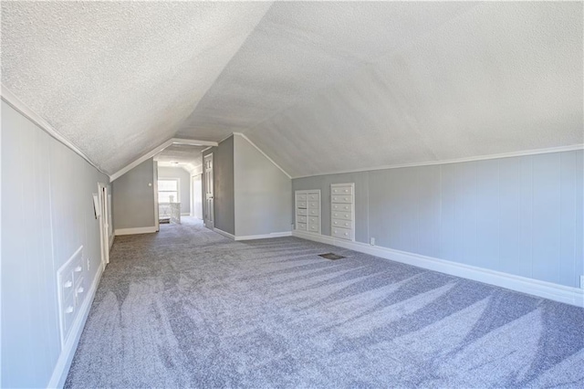 bonus room with carpet flooring, a textured ceiling, and lofted ceiling