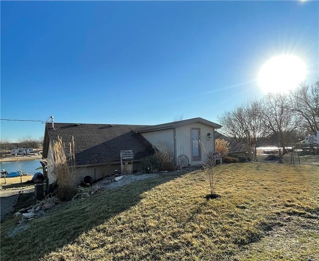 view of side of home featuring a lawn