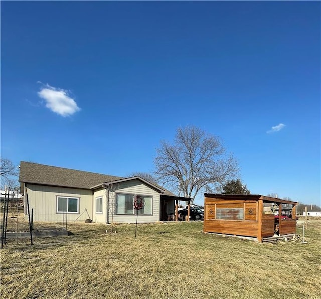 rear view of property with a yard