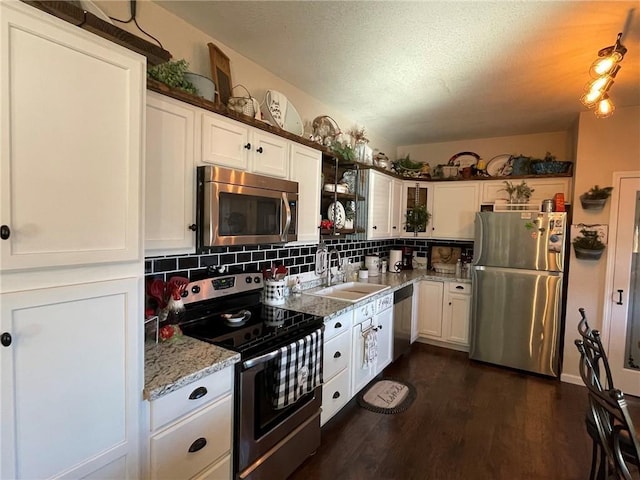 kitchen with white cabinets, dark hardwood / wood-style flooring, sink, and appliances with stainless steel finishes