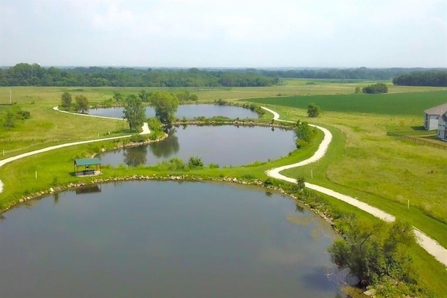 birds eye view of property featuring a water view and a rural view