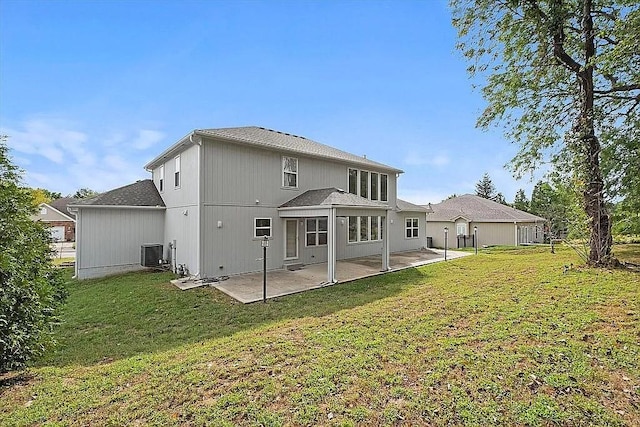 back of property featuring a yard, a patio, and central AC