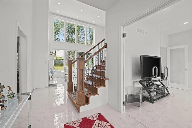 17012 E 38th Ter S, Independence, MO 64055 - foyer entrance with marble tiled floors, a towering ceiling, healthy amount of natural light, stairs, and recessed lighting