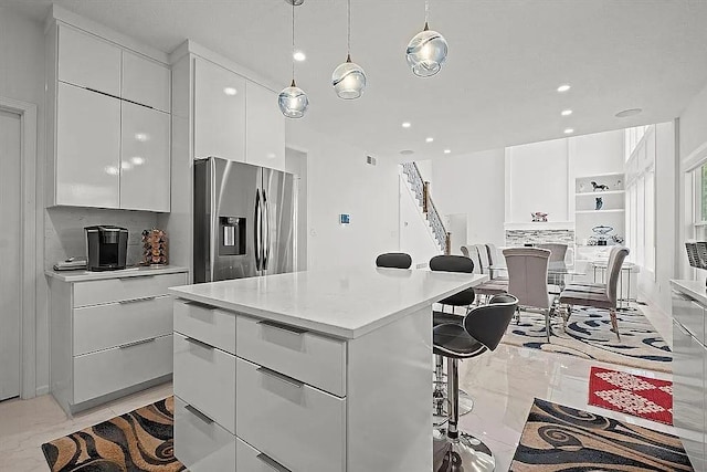 17012 E 38th Ter S, Independence, MO 64055 - kitchen with stainless steel refrigerator with ice dispenser, modern cabinets, a kitchen bar, light marble finish flooring, and recessed lighting