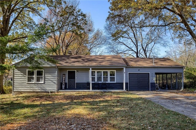 single story home with a garage, a front yard, and a carport