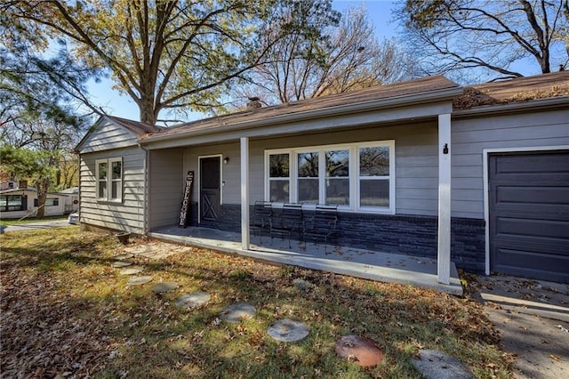 view of front of home with a porch and a garage