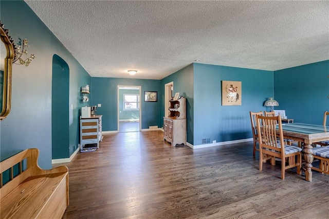 dining room with hardwood / wood-style floors and a textured ceiling