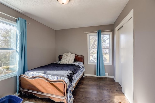 bedroom with dark hardwood / wood-style flooring and a textured ceiling