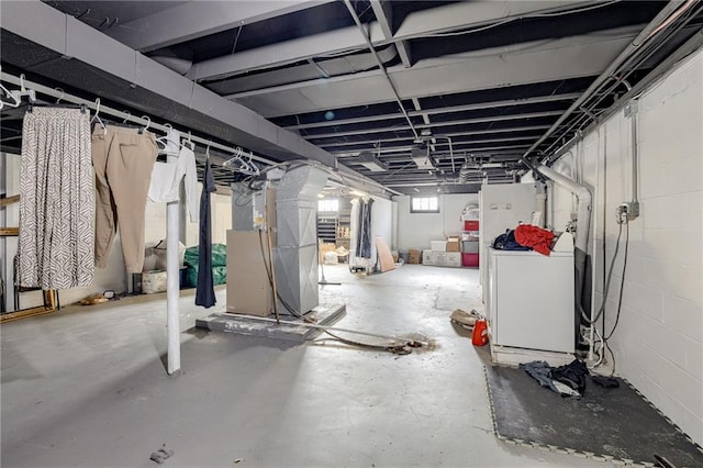 basement featuring washer / dryer and heating unit