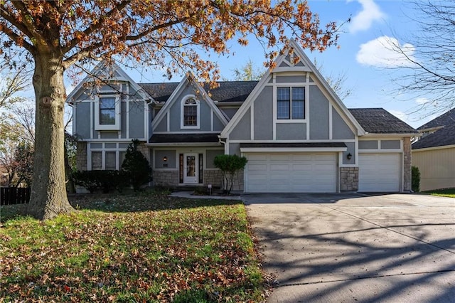 english style home featuring a front yard and a garage