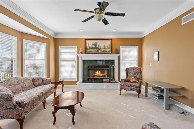 living room with light carpet, a fireplace, ceiling fan, and ornamental molding