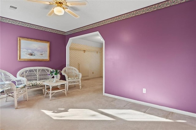 sitting room featuring light carpet and ceiling fan