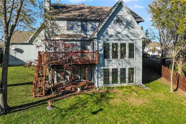 rear view of house with a lawn and a deck