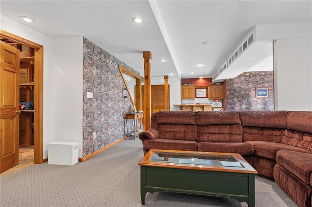 living area with recessed lighting, light carpet, and baseboards