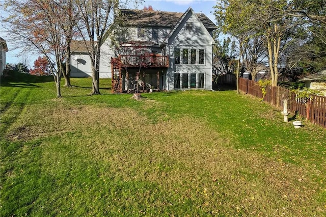 exterior space with a lawn, fence, and a wooden deck