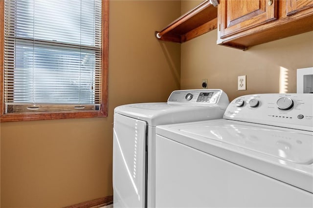 laundry area featuring cabinets and washing machine and clothes dryer