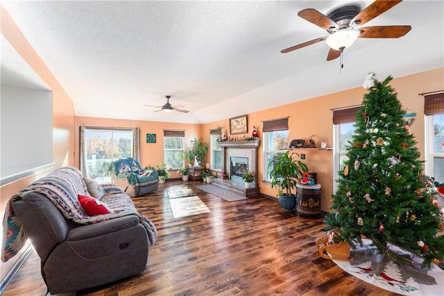 living room with wood-type flooring, a textured ceiling, and ceiling fan