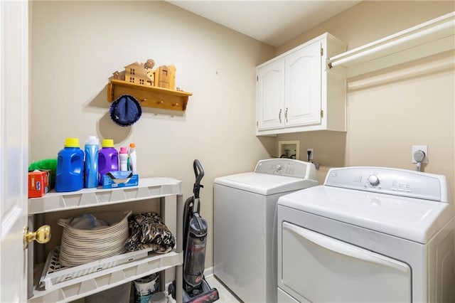 laundry room with washing machine and dryer and cabinet space