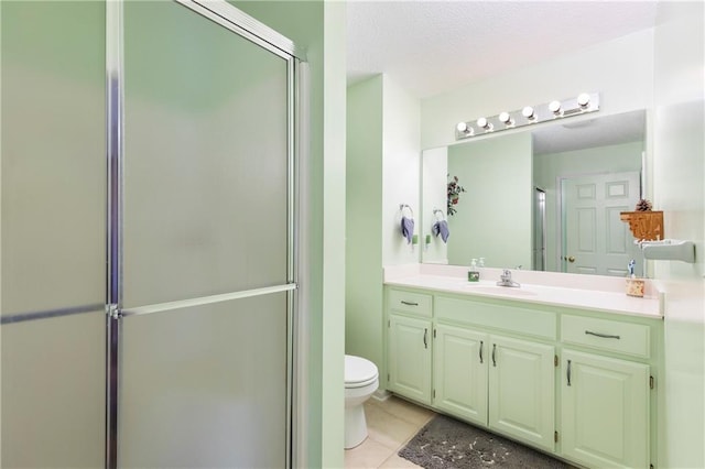 bathroom featuring a textured ceiling, toilet, a shower with shower door, vanity, and tile patterned floors