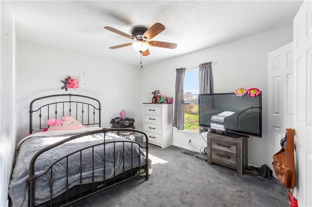 bedroom featuring a textured ceiling, carpet floors, and ceiling fan