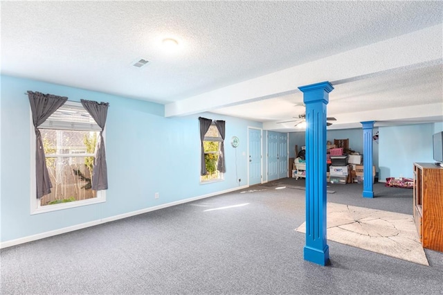 basement with carpet, visible vents, ceiling fan, a textured ceiling, and baseboards