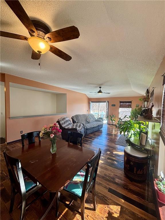 dining room featuring a textured ceiling and wood finished floors