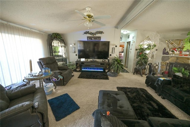 carpeted living room with vaulted ceiling, a stone fireplace, ceiling fan, and a textured ceiling