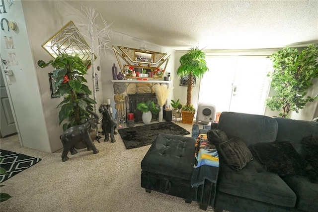 living room featuring carpet flooring, a stone fireplace, and a textured ceiling