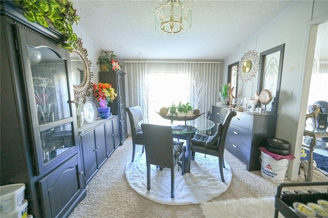 carpeted dining space featuring a chandelier and a textured ceiling