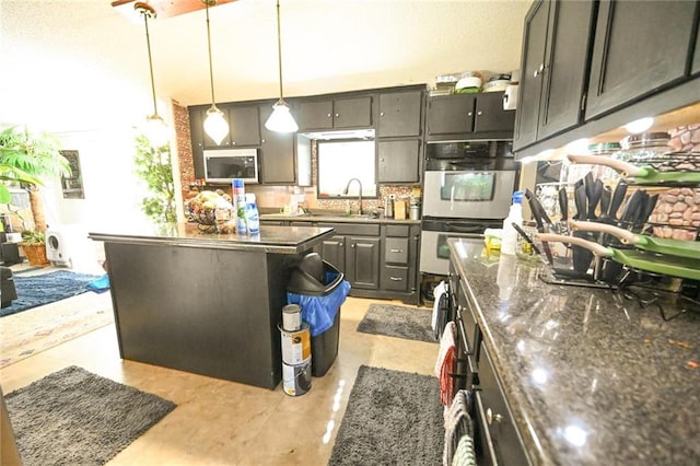 kitchen featuring pendant lighting, backsplash, double wall oven, dark stone countertops, and a kitchen island