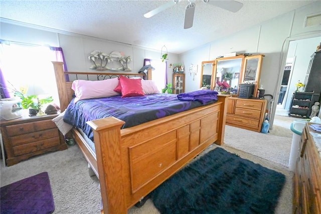 carpeted bedroom with a textured ceiling, ceiling fan, and lofted ceiling