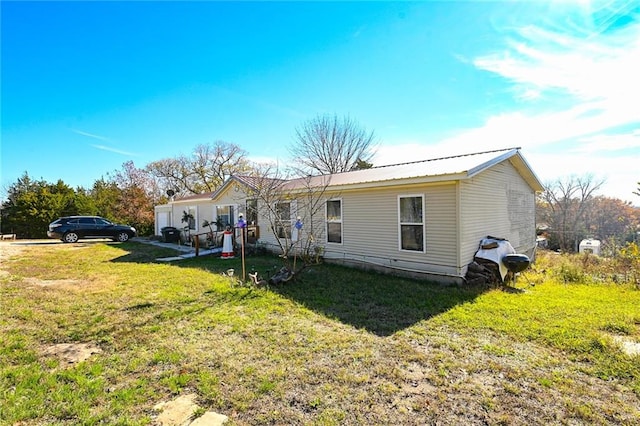 rear view of property featuring a lawn