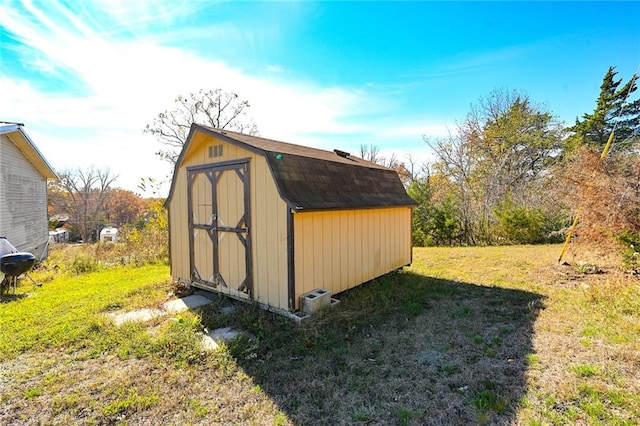 view of outdoor structure featuring a lawn