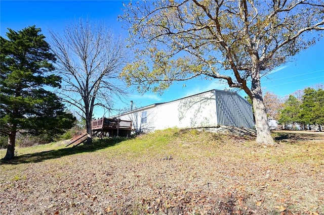 view of property exterior with a deck