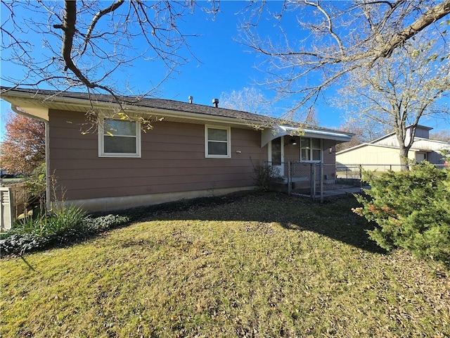 rear view of house featuring a yard